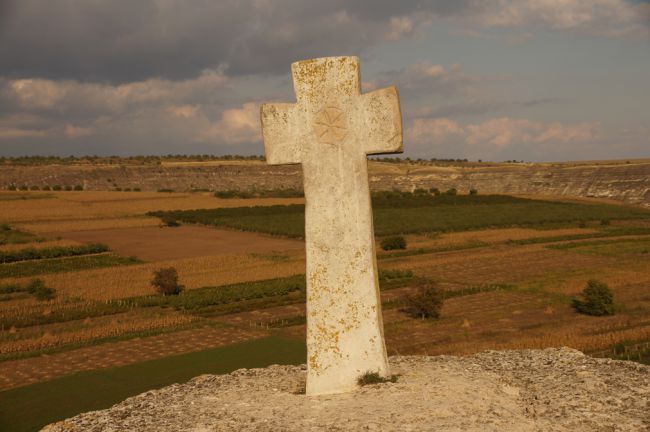 Old stone cross within the landscape of Butuceni